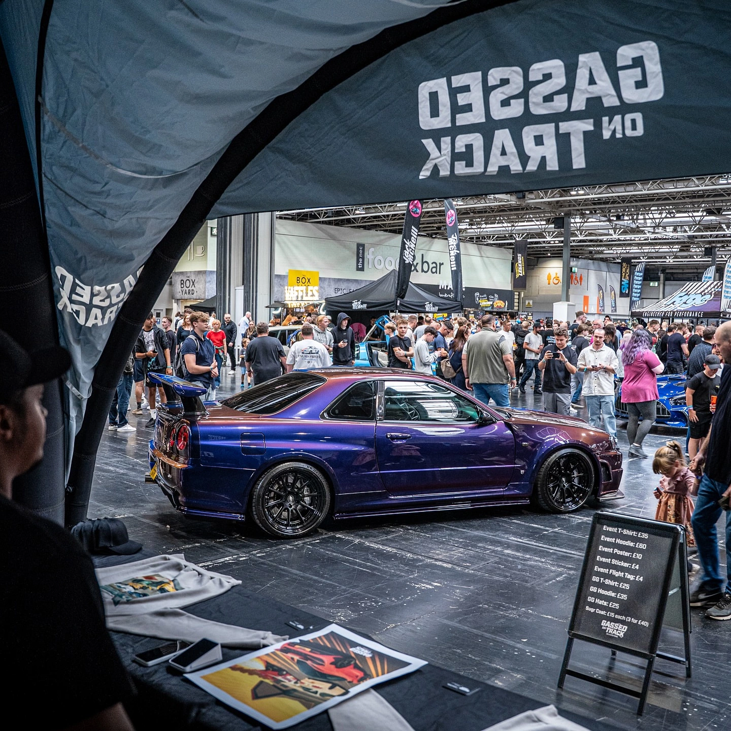 Gassed On Track booth interior view with merch